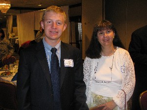 In June, the chapter's science fair winner, John Parish IV, receives $3,000 to attend the national competition in Florida as his mother, Maureen Parish, looks on.