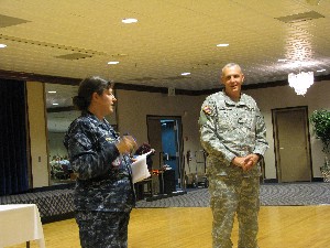 Col. Michael Curry, USA, chapter president, thanks Rear Adm. Janice Hamby, USN, director, command and control systems, North American Aerospace Defense Command and U.S. Northern Command, for speaking at the June meeting.