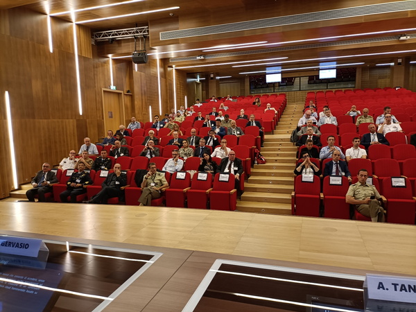 In July, audience members listen to the conference overview.