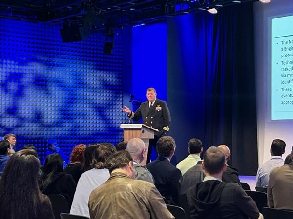 Donald Costello, assistant professor and associate chair, U.S. Naval Academy, speaks to the audience at the March event.