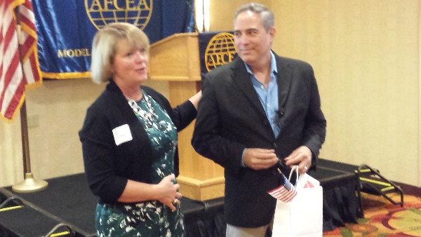 Virginia Bayer, the chapter's vice president of programs, thanks Bryan Lopez, who gave an industry overview of the Information Dominance Corps, in October. 