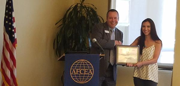 Chapter President Trevor Bender presents a $3,000 science, technology, engineering and mathematics (STEM) Major Graduate Diversity Scholarship to Lauren Gillespie during the chapter's monthly luncheon in October.