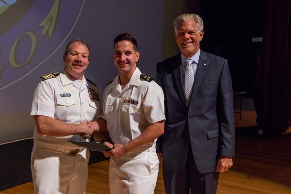 Capt. Dave Grundies, USN (Ret.), chapter chairman of the board (r), and Capt. Edwin Kaiser, USN, commanding officer, Naval ROTC San Diego Consortium (l), present the AFCEA ROTC Honor Award in April to Midshipman Mitchel DiLorenzo, USN. 