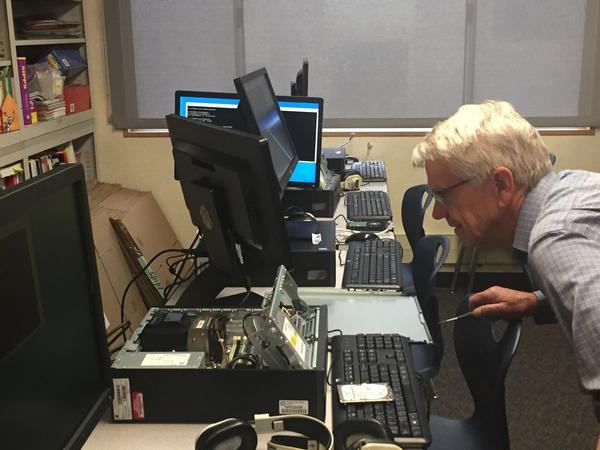 Chapter Member Tom Howard installs a refurbished computer at Hilltop Elementary School in Chula Vista, California, in December.