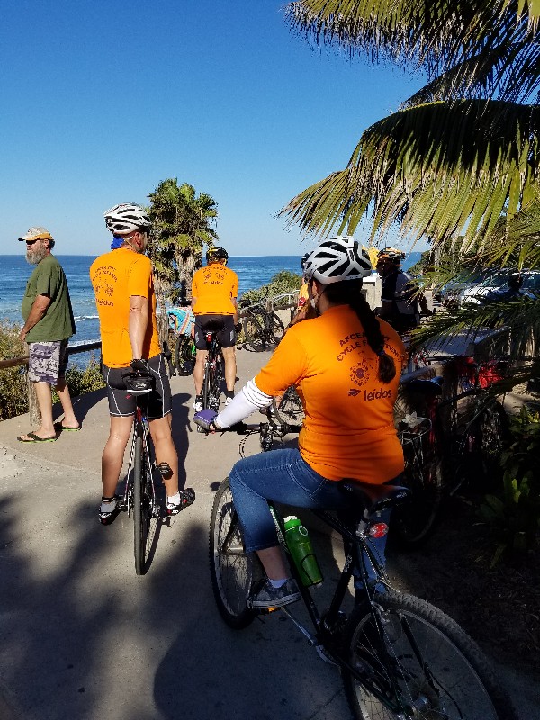 Riders in the April Cycle for STEM event take a break and enjoy the view at Swami's State Beach in San Diego.