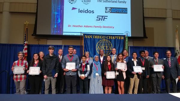 Middle and high school students receive Science Fair Recognition Awards for STEM Excellence at the May symposium. 