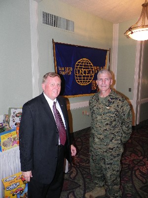 Jim Loiselle (l), chapter president, and Col. Frank A. Richie, USMC, commanding officer, Marine Corps Air Station Miramar, present the donations collected for Toys for Tots in December.
