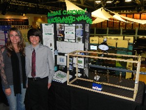 The chapter devotes a section of its April symposium exhibit to its science fair winners.
