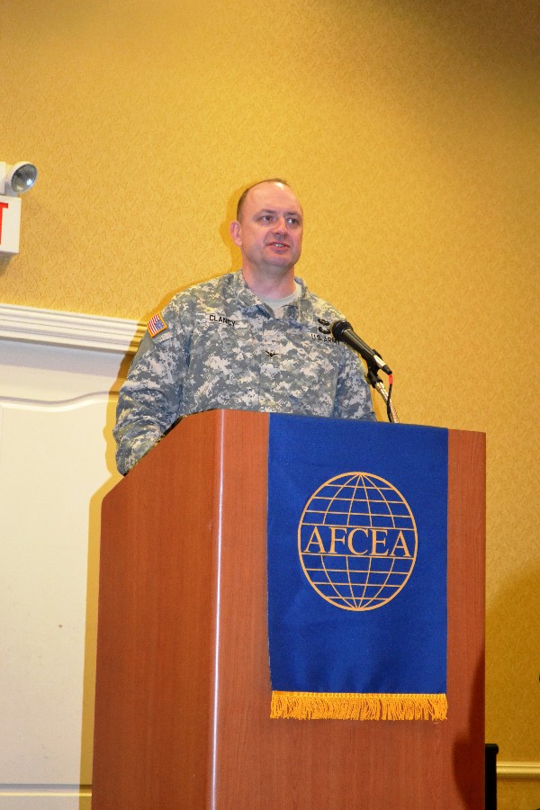 Col. Tom Clancy, USA, chief, U.S. Transportation Command Joint Cyber Center, presents three 