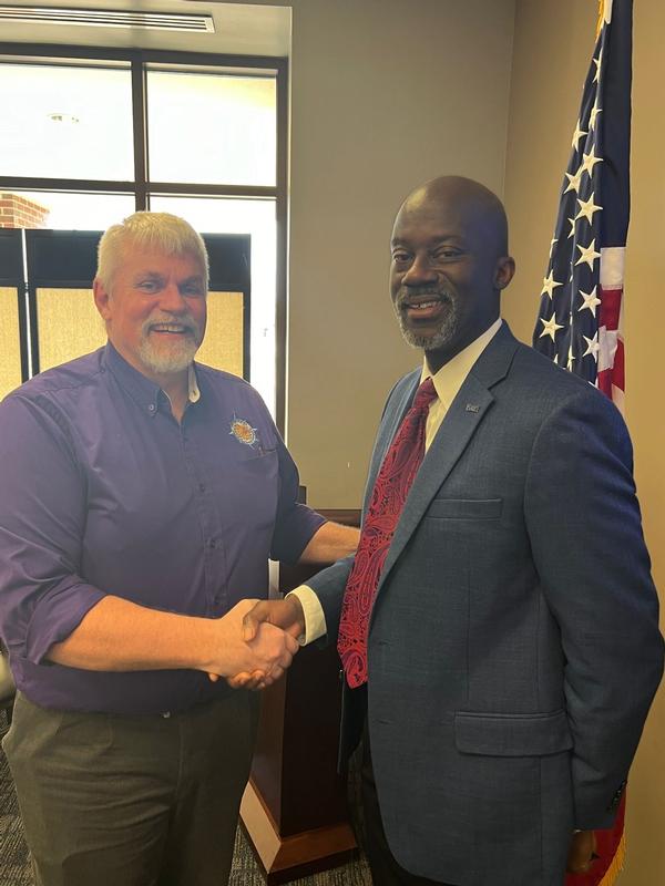 Burton poses for a photo with Chapter Vice President Carlos Alford at the January Luncheon.