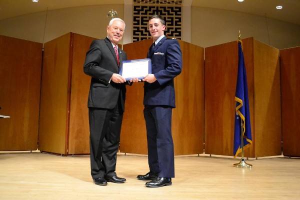 Bob Landgraf, chapter member, presents the AFCEA Honor Certificate to Cadet Robert Powell in May.