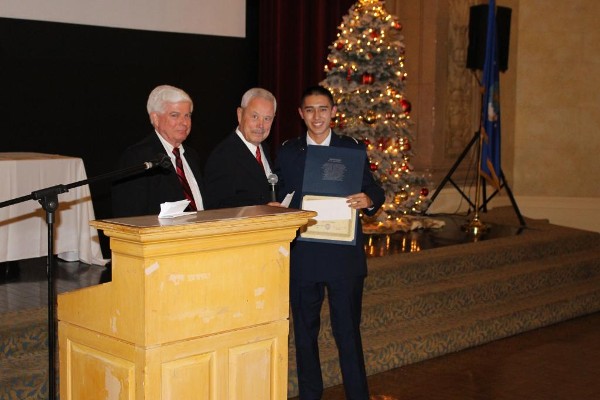 At the December Air Force ROTC Detachment 045 Fall Dining-Out, Bob Moorhead (l), chapter president, and Bob Landgraf, former regional vice president (c), present Steven Wong a scholarship check and certificate.