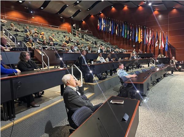 Attendees listen to presentations in the amphitheater during the November event.