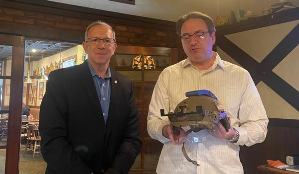Glenn Kesselman, chapter president, and Andrew Watters demonstrate a wearable helmet at the February Luncheon.
