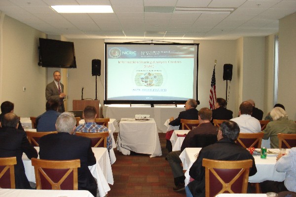 Buehler talks about the Information Sharing and Analysis Centers (ISACs) at the November chapter event.