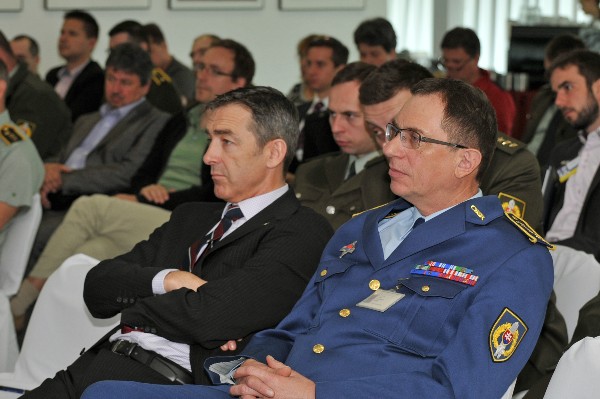 In May, Chris Stace, senior project manager, European Defence Agency (l) and Col. Ivan Ilavsky, Ministry of Defence Slovakia, listen to a speaker during the Defence Fair-IDEB 2014.