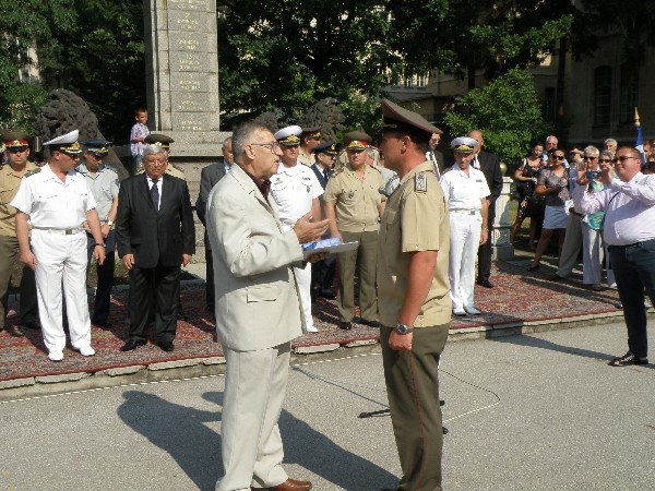 In July, Dr. Simeon Kralikov (l), chapter president, presents the chapter's award for outstanding achievement in the field of communication and information systems to Maj. Valeri Lyubomirov (r) while members of the Ministry of Defense stand by.