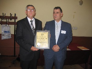 Col. Simeon Kralikov, BA (l), presents a new corporate membership plaque to Rossen Natzkov on behalf of Multi Media Group in May.