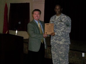 Brig. Gen. LaWarren Patterson, USA (r), deputy commander, U.S. Army Network Enterprise Technology Command/9th Signal Command, accepts a token of appreciation from Richard Besselman, chapter president, for speaking at the September meeting.