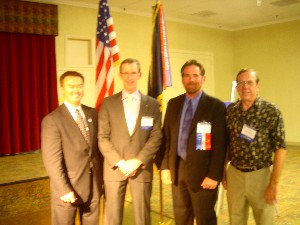 At the conference dinner in October, attendees await the evening's agenda, including (l-r): Richard Besselman, chapter vice president of publicity; Jerry Proctor, USAIC; Larry Singer, chapter president; and Larry Bingaman, chapter treasurer.