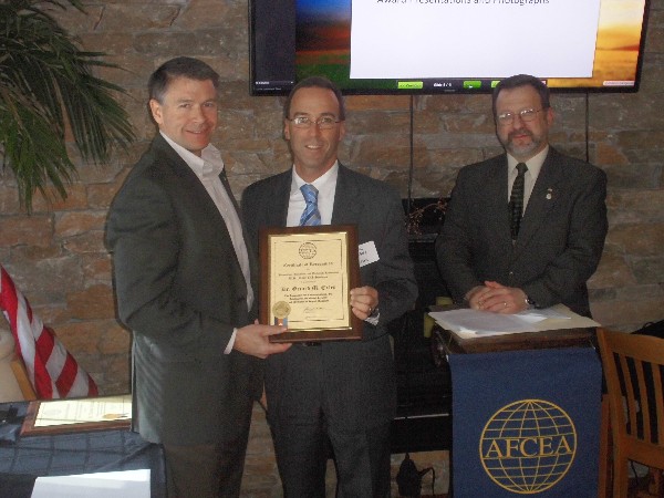 In February, Shannon Sullivan (l), AFCEA regional vice president, and Lee Rossetti (r), chapter president, present a special award to Eric S. Spigel on behalf of Dr. Gerard M. Exley from the Naval Undersea Warfare Center.