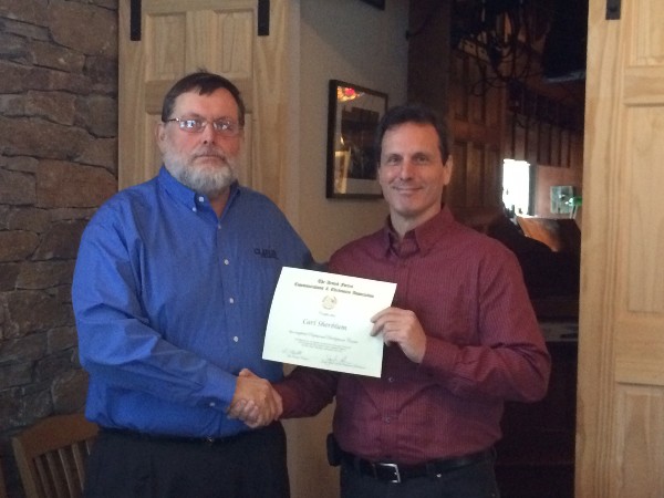 Loda presents a certificate to Carl Sherblum in February.