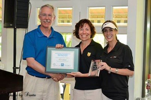 Representatives from FireEye Incorporated, the title sponsor for the October scholarship golf tournament, join Col. Maria Barrett, USA (c), chapter president and J-6 director and chief information officer, U.S. Southern Command.