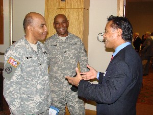 In June, Brig. Gen. Nolen V. Bivens, USA (l), talks with Col. Herb Newman, USA ©, chapter president, and Dr. Ben Amaba, IBM Global.
