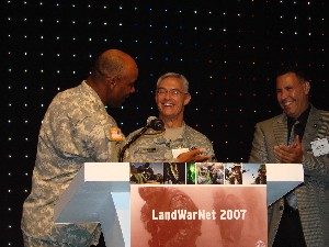 Col. Herb Newman, USA (l), chapter president, thanks Maj. Gen. (P) Jeffrey A. Sorenson, USA (c), Army CIO/G-6 Nominee, for speaking at the LandWarNet 2007 chapter luncheon in August, Pictured on the right is Mr. Gabriel Ruiz from CDW-G, the luncheon sponsor.