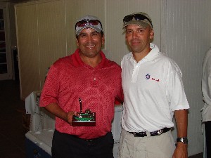 Mario Garza (l), assistant deputy director, Country Insight Policy and Strategy Directorate, U.S. Southern Command (SOUTHCOM), accepts a trophy from Col. Mark Churchwell, USA, chief information officer and director, command, control, communications, computer systems and information, Headquarters SOUTHCOM, and chapter president, after the October golf tournament and fundraiser.