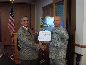 Col. Mark Churchwell, USA (r), chapter president, presents a certificate of appreciation to Dr. Saeed Rajput, assistant director of mathematics, computer science and technology at Nova Southeastern University. Rajput was the April luncheon's guest speaker.
