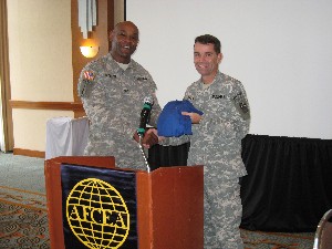Col. Herb Newman, USA (l), chapter president, presents an chapter logo polo shirt to March guest speaker Brig. Gen. Richard T. Ellis, USA, director of intelligence (J-2), U.S. Southern Command.