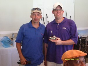 Col. Mark Churchwell, USA (l), chief information officer and director, command, control, communications, computer systems and information (C4I), Headquarters U.S. Southern Command (SOUTHCOM), and chapter president, congratulates Bill Mester, mission assurance support capability representative from the Defense Information Systems Agency field office, for his performance at the chapter's October golf tournament and fundraiser.