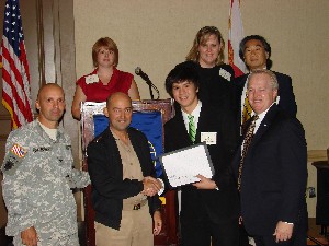 At SOUTH 2008 in October, Mylo Cheng (2nd from r), 2008 scholarship winner, receives his $2,500 check. From l-r are Col. Mark Churchwell, USA, director, command, control, communications, computer systems and information, Headquarters SOUTHCOM; Adm. Stavridis; Cheng; and Mark Nehmer, chapter scholarship chair. Top row l-r are Patti Botteicher, president for the Young AFCEAN committee and the luncheon's Master of Ceremonies; and Mr. and Mrs. Cheng, parents of Cheng.