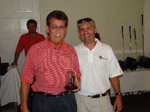 Scott Carden (l) receives a trophy for Longest Drive from Col. Churchwell at the golf tournament and fundraiser, held in October.