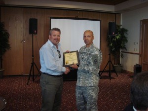 In November, Col. Mark Churchwell, USA (r), chief information officer and director, command, control, communications, computer systems and information (C4I), SOUTHCOM, and chapter president, presents a certificate and pin to Al Hicks, an operations manager from General Dynamics who works in the intelligence directorate at SOUTHCOM, in recognition of his lifetime membership.