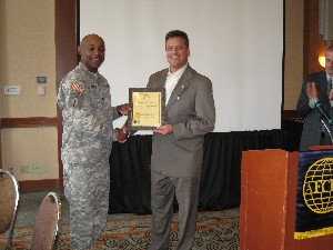 Col. Newman (l) presents a new corporate member certificate in March to John Mahan of Proton Data Security LLC.