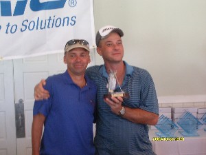 Col. Churchwell (l) congratulates Master Sgt. Tod Hartwick, USAF, C4I configuration management assistant, digital synergy division, C4I directorate, SOUTHCOM, for winning the longest drive award at the chapter's October event.