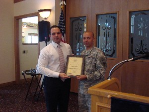 On behalf of The Academy, Andy Perez (l) accepts a new corporate membership certificate from Col. Churchwell at the chapter's February meeting.