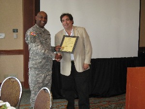 Col. Newman (l) presents a new corporate member certificate to Howard Melamed of CellAntenna Corporation in March.
