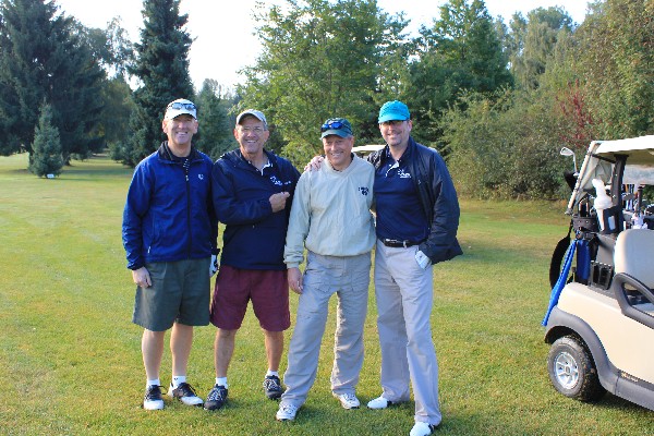 Jim Condon, vice president, International Division, DRS, pauses with DRS teammates between holes at the chapter's Golf Classic in September, which raised funds for education.