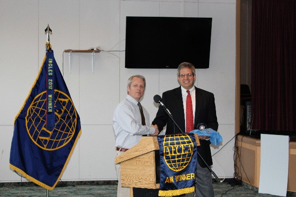 Roger Carpenter (l), chapter president presents Timothy Bootle, infrastructure senior manager for outside the contiguous United States, Space and Naval Warfare Systems Command, Systems Center Atlantic, with a chapter coin and golf shirt as tokens of appreciation following his presentation to the chapter in November.