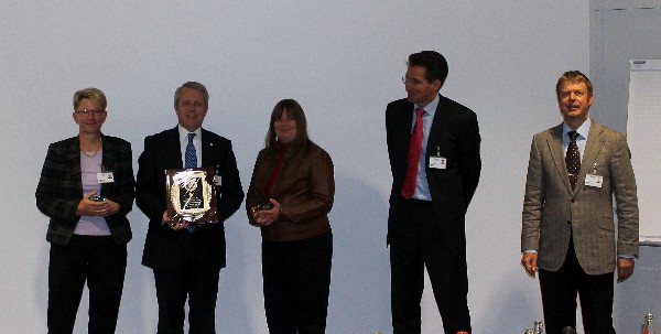 Roger Carpenter (2nd from l), chapter president, presents IBM representatives with chapter coins as tokens of appreciation for hosting the chapter members at their facility in October. IBM personnel are (l-r) Annelie Graf-Killes, Monique Seiber, Andreas Plach and Stefan Hoffman.