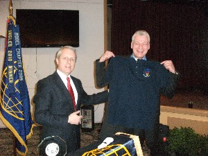 Roger Carpenter (l), chapter president, presents Simon with a chapter golf shirt following his speech in January. 