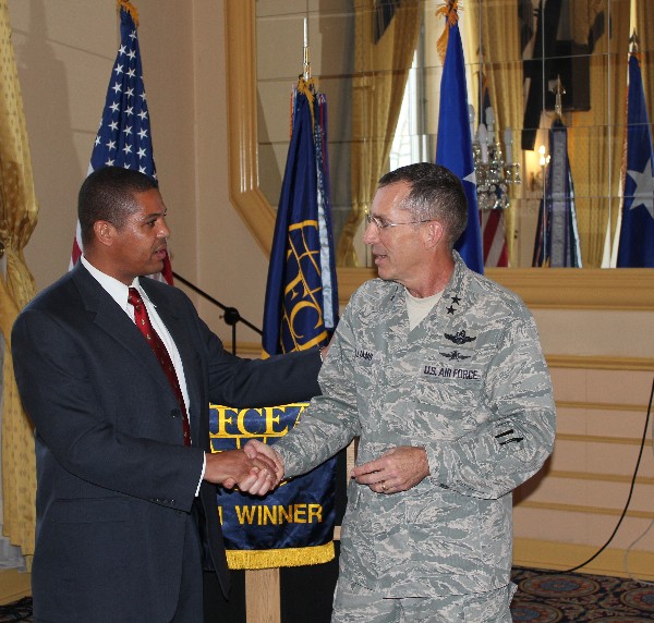 Michael Young, chapter vice president, presents Gen. Williams with a chapter coin to thank him for speaking at the December luncheon.