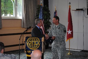 Roger Carpenter (l), chapter president, presents Gen. Pollett with a chapter golf shirt following the general's speech in August.