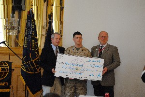 In October, Sgt. Nick Anderson, USMC (c), receives a $2,000 scholarship from the chapter and CSC presented by Carpenter (l) and Bill Kroelinger, CSC site manager.
