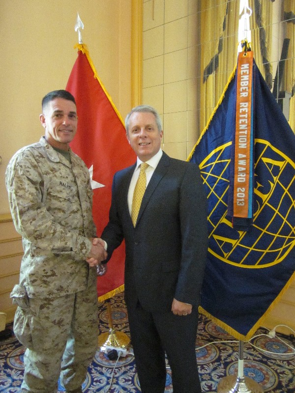 Roger Carpenter, chapter president, presents Gen. Nally with a chapter coin and plaque to thank him for speaking at the September chapter luncheon.