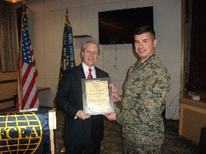 In January, Maj. Oscar Alanis, USMC (r), chapter vice president, presents Carpenter an AFCEA Life Membership certificate. 