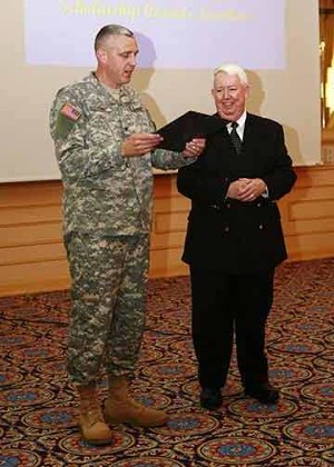 At the June scholarship luncheon, Col. Mike Curry, USA (l), chapter president, presents Dr. Jospeph T. Page Jr., chapter secretary, with a lifetime membership in AFCEA.  
